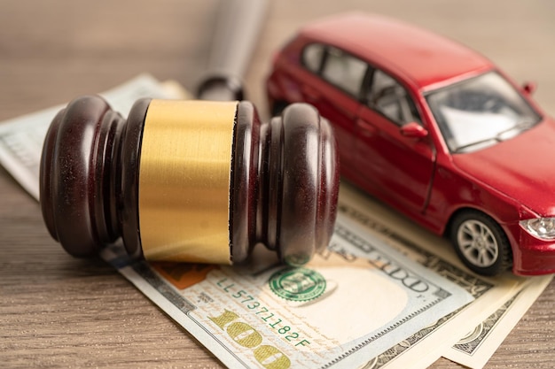 Gavel for judge lawyer with car on US dollar money banknotes Car loan Finance saving money law insurance and leasing time concepts