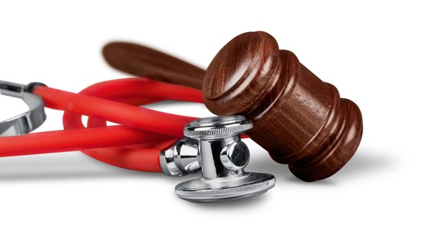 Gavel and stethoscope  on background, symbol photo for bungling and medical error