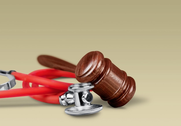 Gavel and stethoscope  on background, symbol photo for bungling and medical error