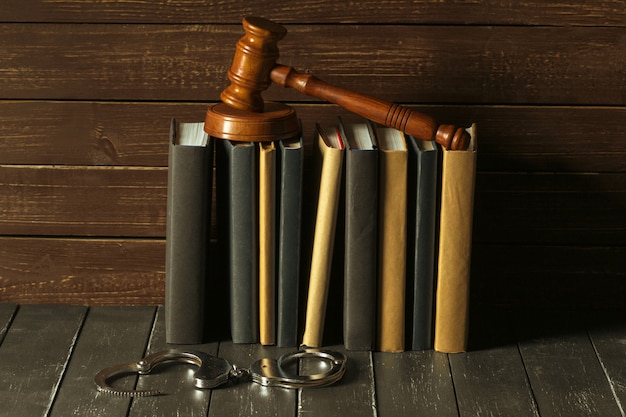 Photo gavel with books on old wooden desk