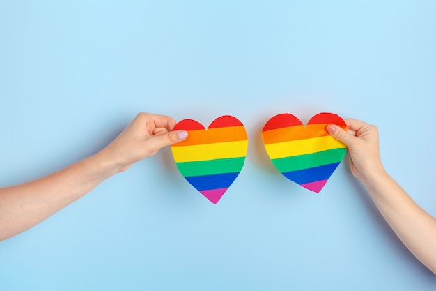 Gay love, Human hand holding a rainbow paper heart