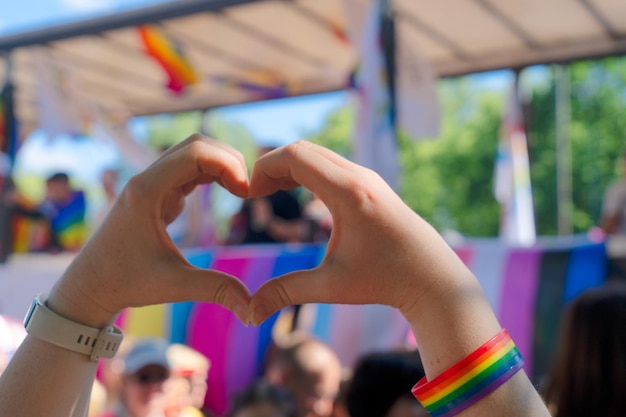 Gay pride parade someone making heart of hands at lgbt parade event