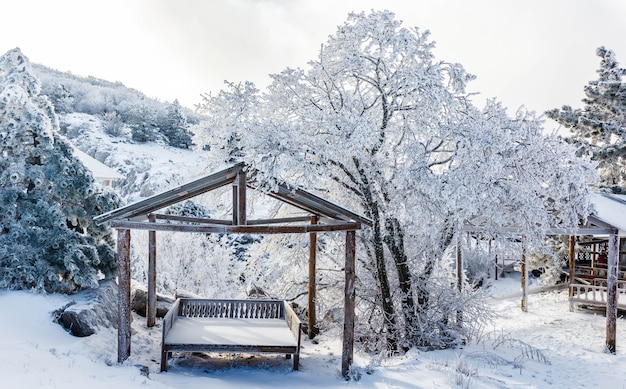 Gazebo for relaxing in a snowy forest in the mountains.