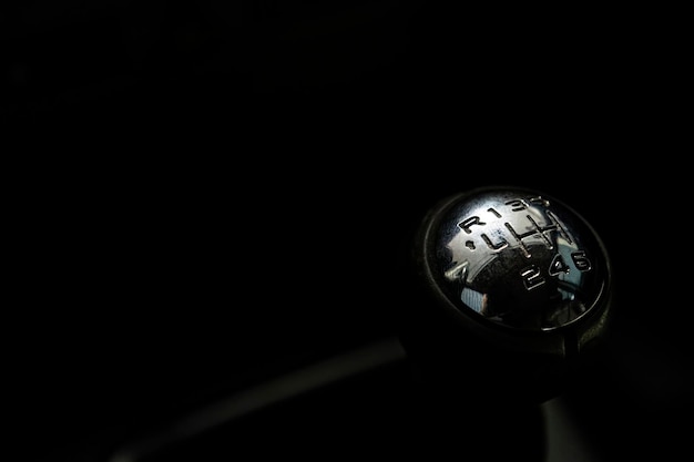 Gear shift lever of the car in the dark background