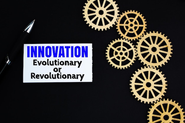 gear teeth and white paper with the words Innovation Evolutionary or Revolutionary