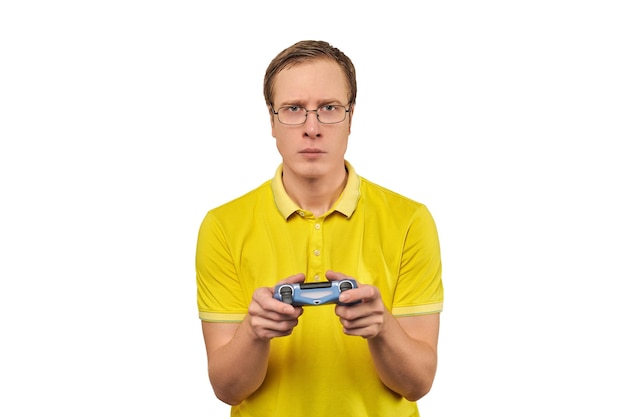 Geek gamer in glasses and yellow Tshirt with gamepad excited video game player isolated on white