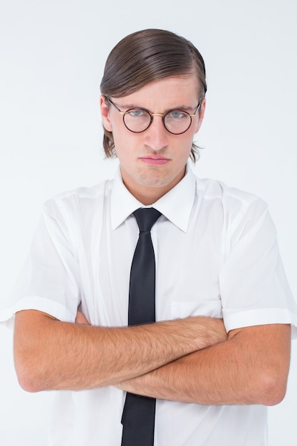 Geeky businessman looking at camera with arms crossed