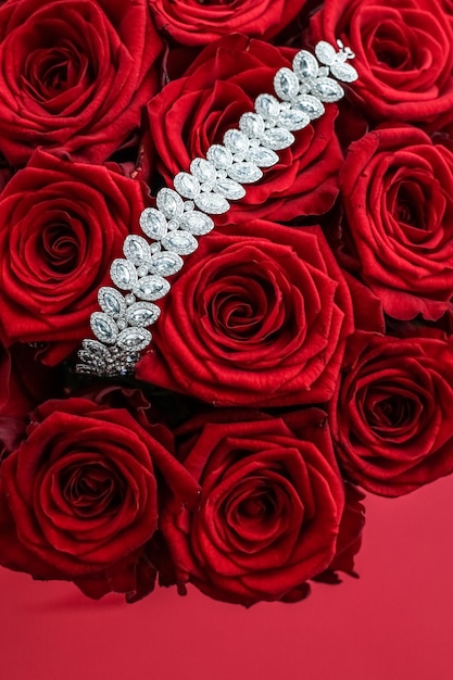 Gemstone jewellery fashion and luxe shopping concept  luxury diamond bracelet and bouquet of red roses jewelry