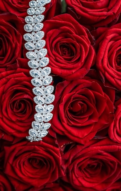 Gemstone jewellery wedding fashion and luxe shopping concept  luxury diamond bracelet and bouquet of red roses jewelry love gift on valentines day and romantic holidays present