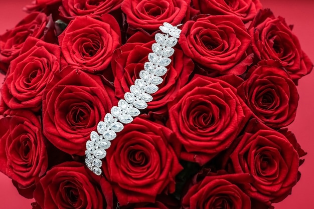 Gemstone jewellery wedding fashion and luxe shopping concept  luxury diamond bracelet and bouquet of red roses jewelry love gift on valentines day and romantic holidays present