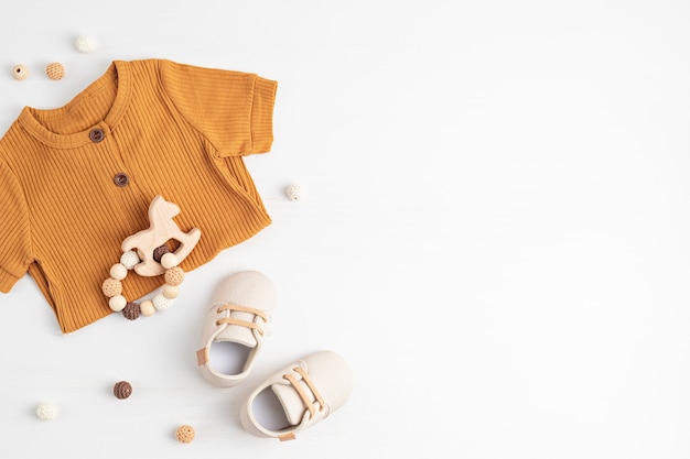 Gender neutral baby garment and accessories. Organic cotton clothes, newborn fashion, branding, small business idea. Flat lay, top view