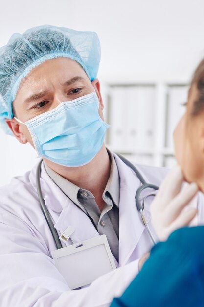 General practitioner examining glands of patient