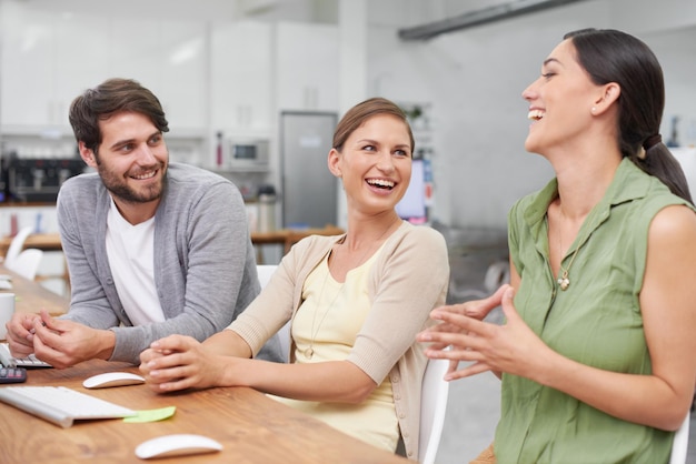 Next generation techies Shot of a group of young businesspeople enjoying a laugh together at their desk