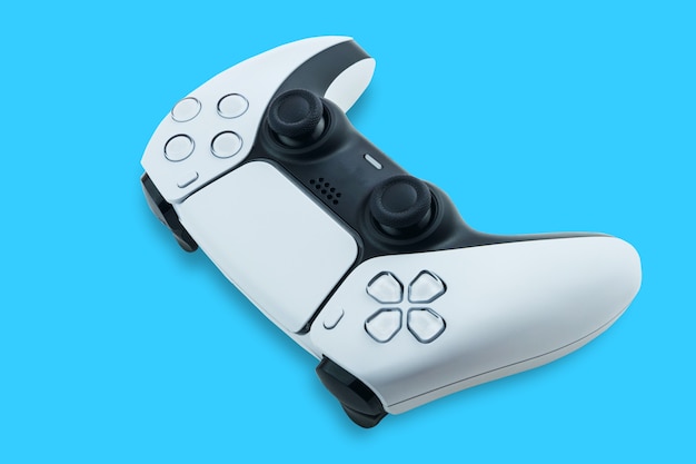 Photo next generation white game controller isolated on blue background. top view.