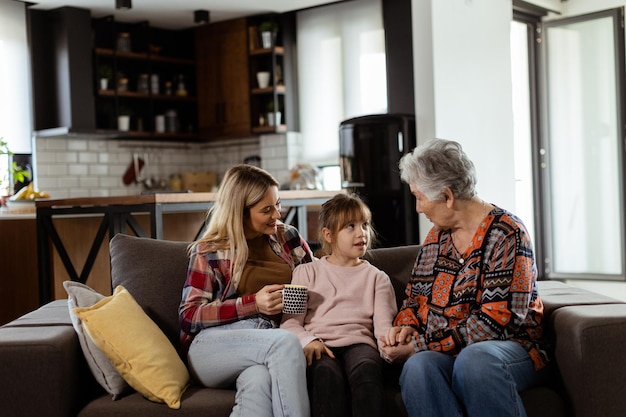 Generational bonding grandmother daughter and grandchild sharing stories on a cozy afternoon