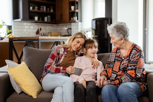 Generational bonding grandmother daughter and grandchild sharing stories on a cozy afternoon