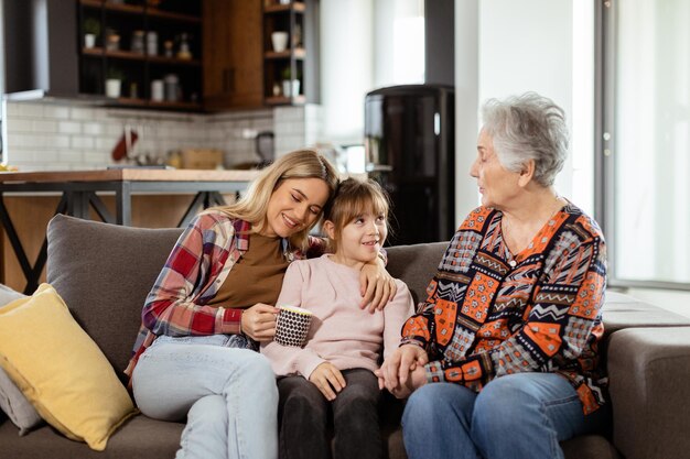 Generational bonding grandmother daughter and grandchild sharing stories on a cozy afternoon