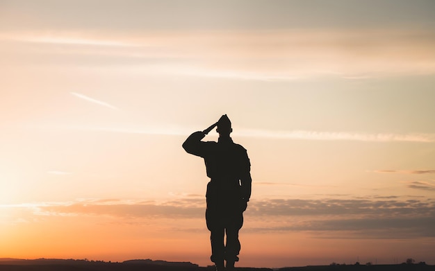 Photo generativeai silhouette of a soldier saluting against a sunset clear area for text