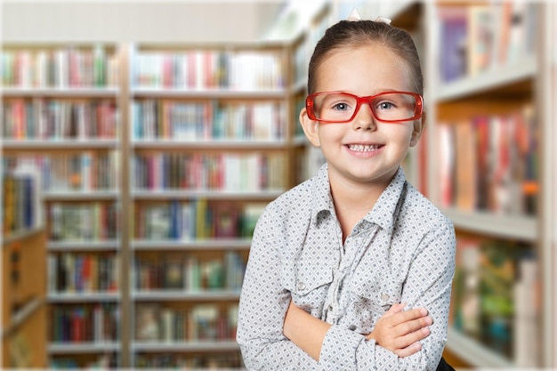 Genius girl in red glasses near blackboard with formulas