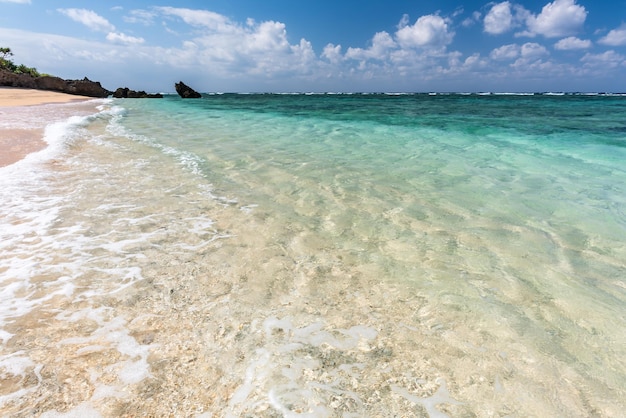 Gentle crystalline wave breaking over the sands along the shore