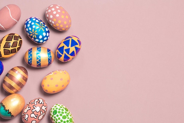 A gentle festive banner colored Easter eggs on a light pink background