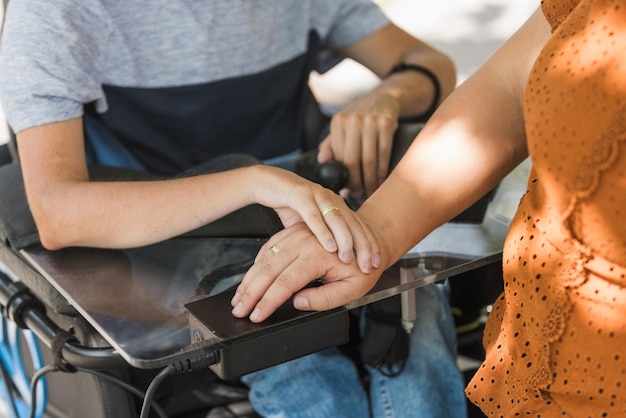 Photo gentle touch of married couple hands man with disability and his wife