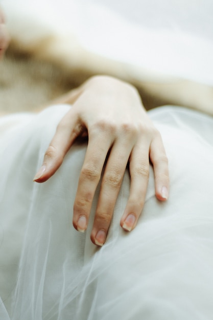 Gently folded hands of a young girl