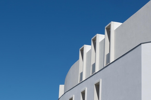 Geometrical details of modern building of white colour with narrow windows in Portugal