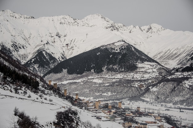 GEORGIA, SVANETI, MESTIA. View from above on the snow covered town under the snowy mountain slope