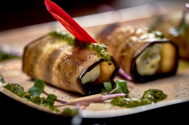 A Georgian appetizer pkhali. Baked eggplant rolls with grated walnut, garlic and cheese.