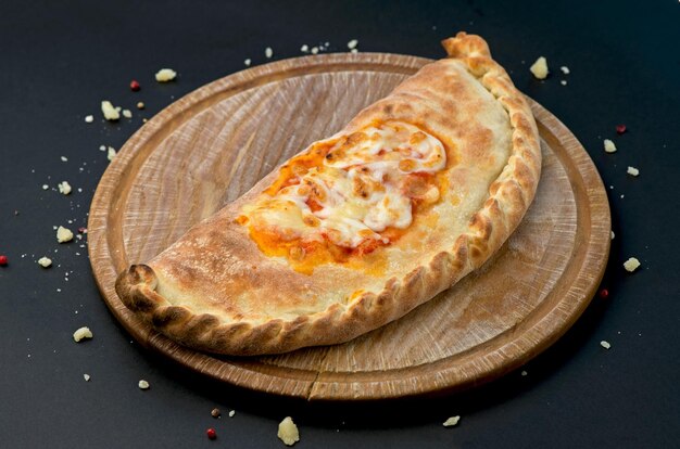 Georgian khachapuri with cheese national traditional cuisine on a black background