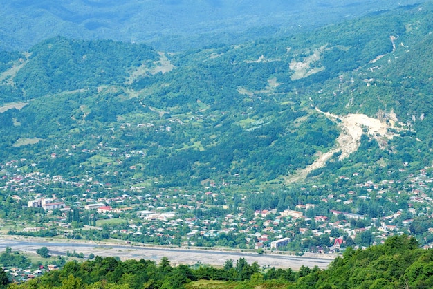 Georgian mountain landscape with a country road a view of the village and a mountain river