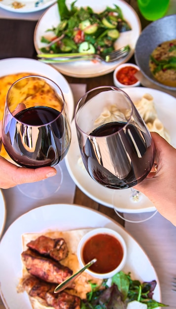 Georgian restaurant food on the table wine in hands