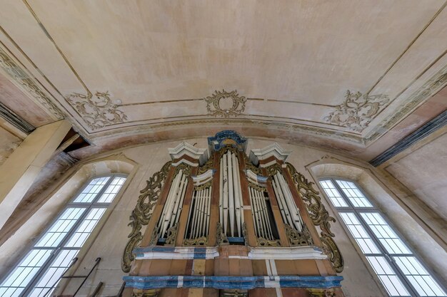 GERANENY BELARUS AUGUST 2020 interior dome and looking up into a old gothic catholic church ceiling with pipe organ