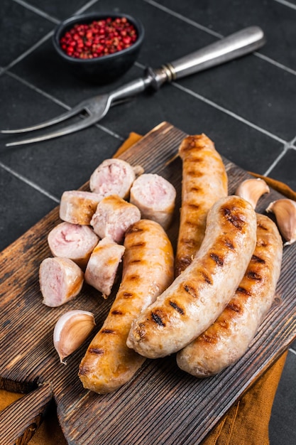 German grilled Bratwurst pork meat sausages on a wooden board Wooden background Top view