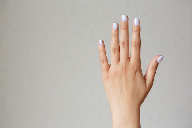 Gesture and sign, female hand showing stop on light. Empty space for text