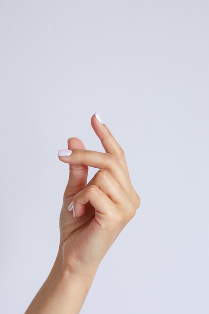 Gesture and sign, female hand on white. hand click or snapping fingers