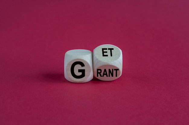 Get grant symbol Businessman turns wooden cubes with concept words Get grant on