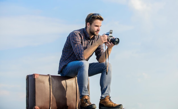 Get out there macho man with camera on baggage photographer in glasses capture adventure journalist sexy man touristic reporter traveler wait for car male fashion style looking trendy