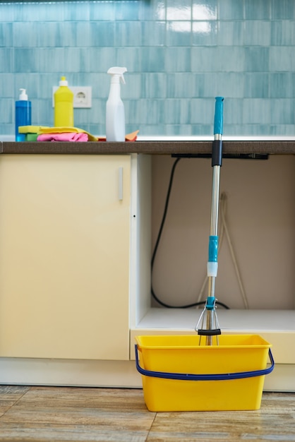 Get your house clean close up shot of floor cleaning bucket with mop and various cleaning