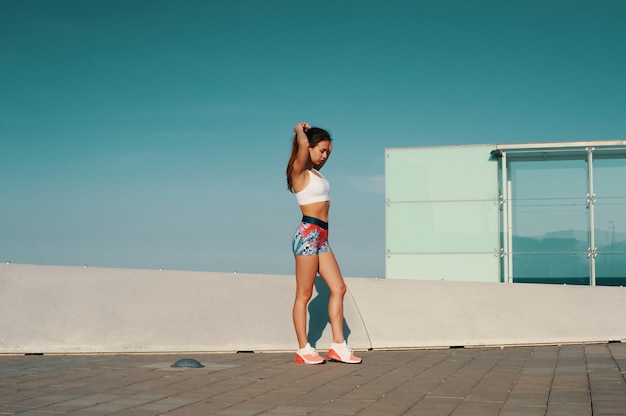 Getting ready. Full length of beautiful young woman in sports clothing getting ready to run while exercising outdoors