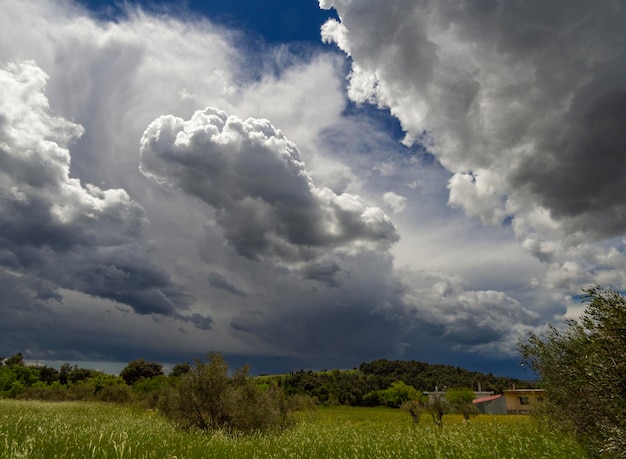 Giant Cumulus clouds before the approaching summer storm in a village on the Greek island in Greece