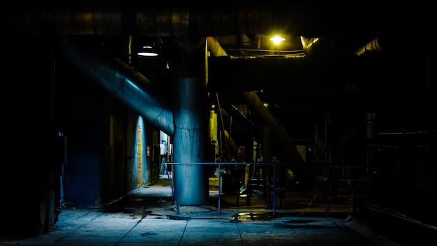 Giant pipes tubes and equipment inside modern industrial power plant night scene Industrial night scene