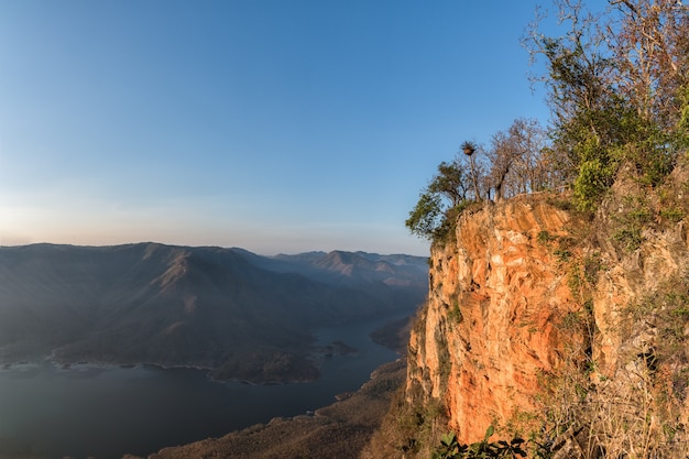 Giant red rock cliff mountian above the lake+