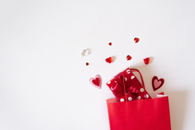 Gift bag with gifts and hearts on a white background. Concept of sales and discounts for Valentine's day