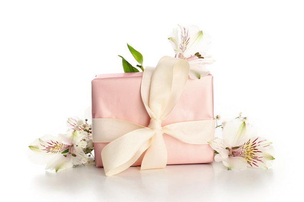 Gift box and flowers isolated on white background