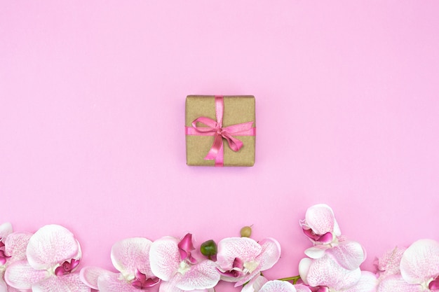 gift box and orchid on pink background