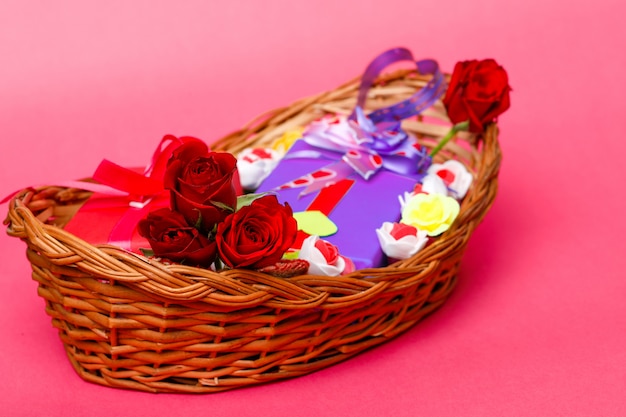 Gift box,red rose flower in wooden basket. Valentine day concept