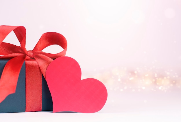 Gift box and valentine card on light pink defocus wall