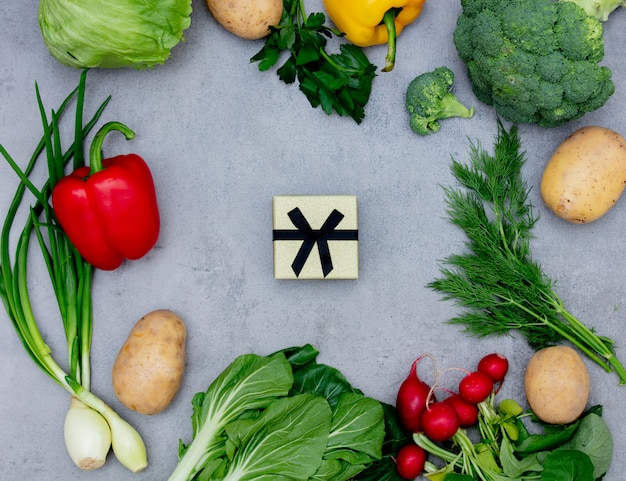 Gift box and vegetables on a table.